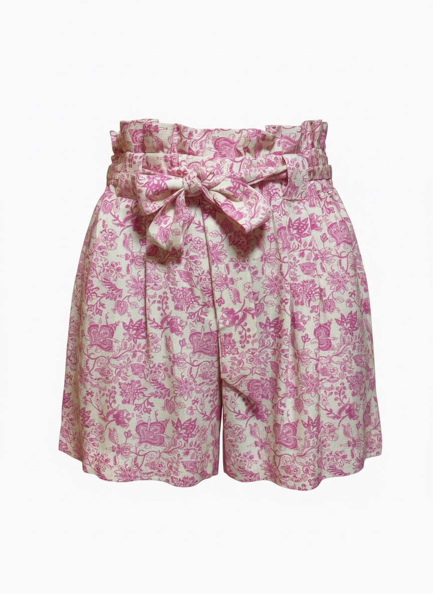 Pink and white toile-print paperbag shorts with a matching fabric tie belt, shown against a plain white background.