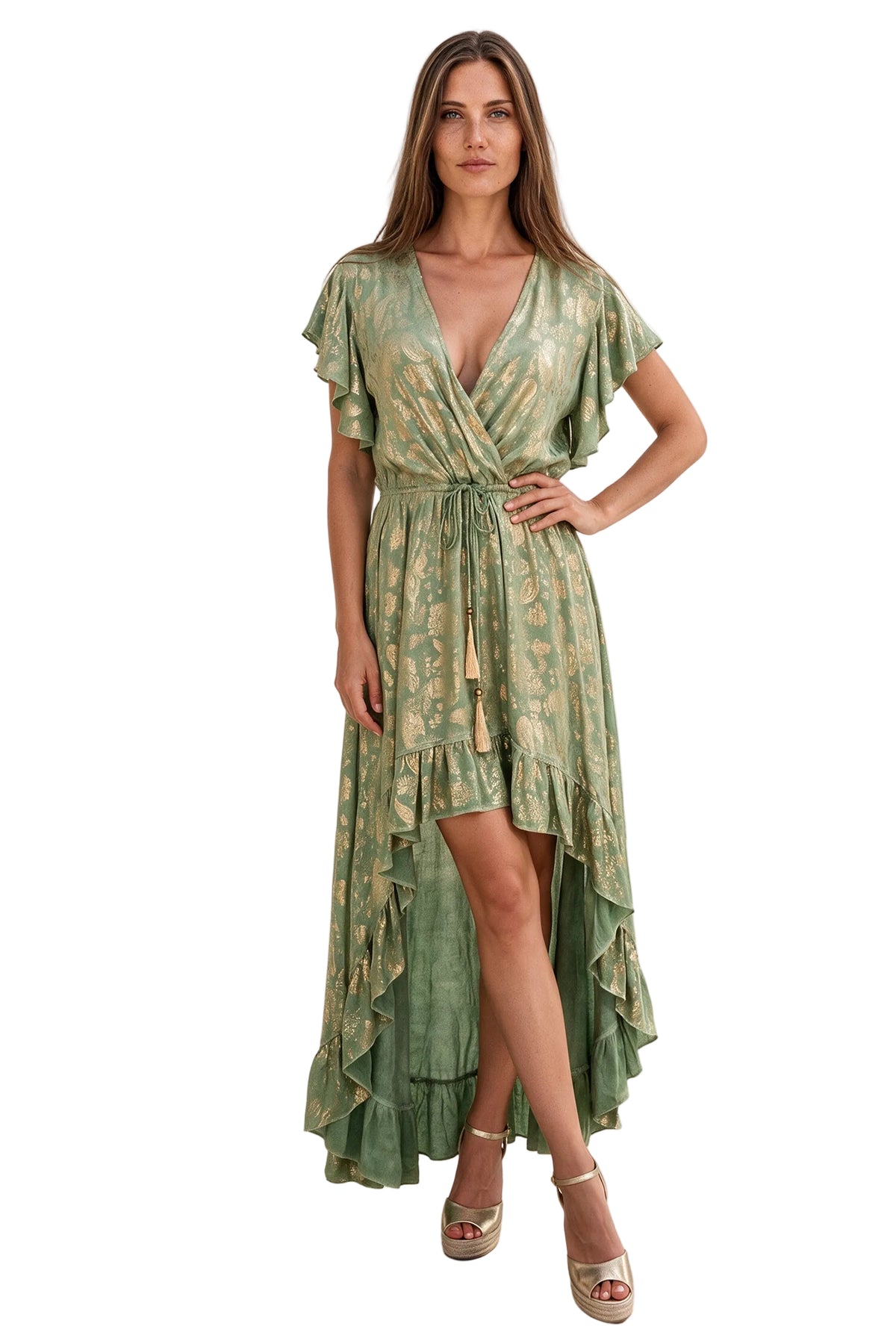 A woman modeling a sage green wrap-style midi dress with a gold floral pattern, ruffled short sleeves, a tie waist, and an asymmetrical ruffled hem, photographed against a plain white studio background.